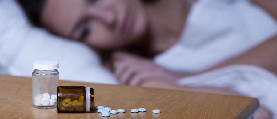 woman taking sleeping pills